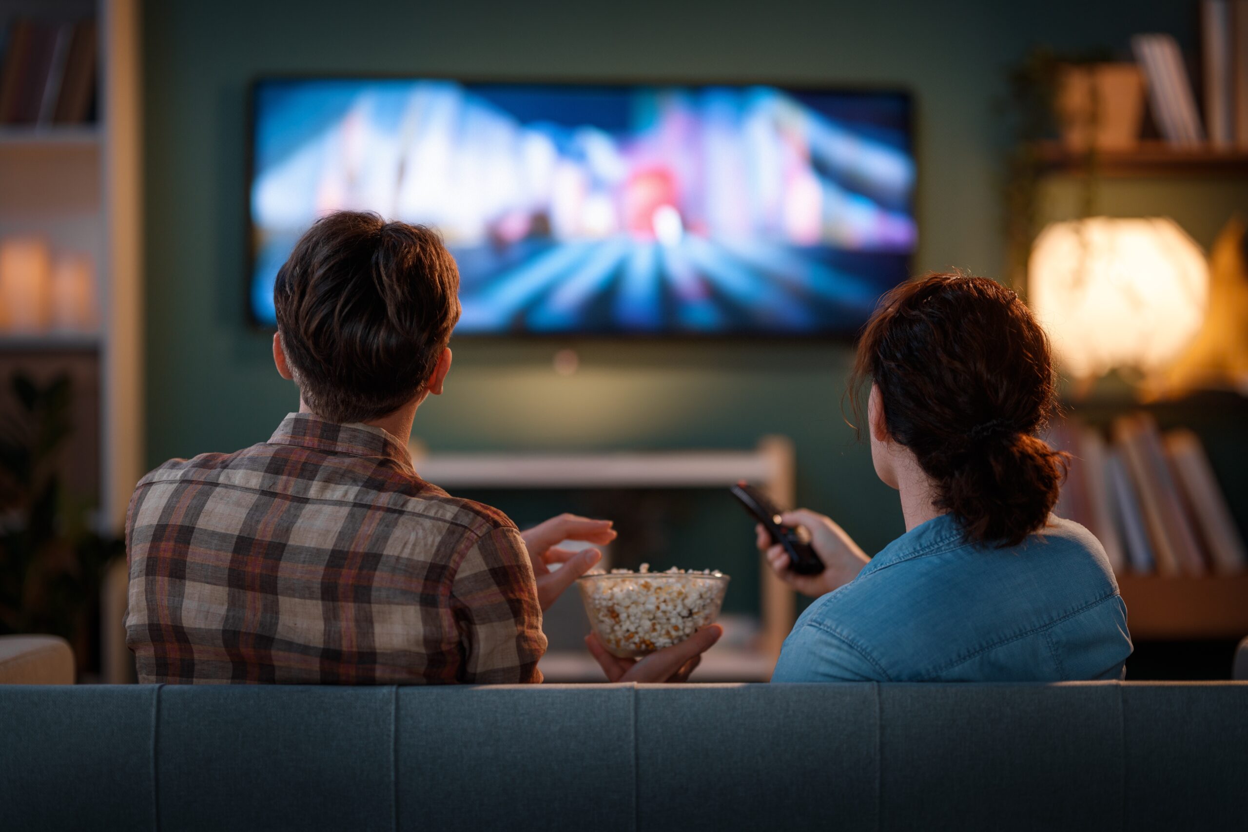 Happy,Family,Watching,Tv,,Movies,In,The,Evening,At,Home.